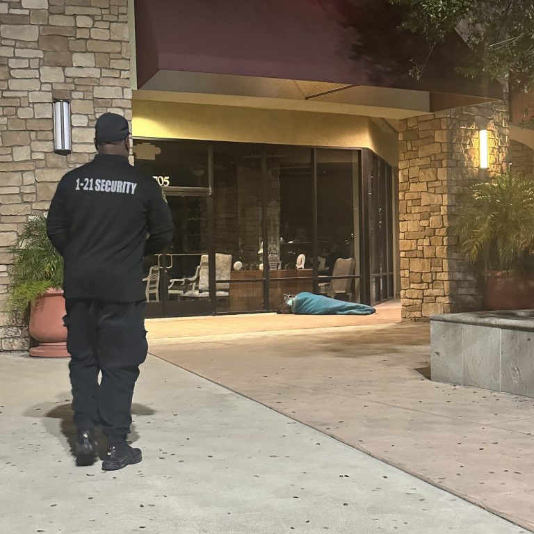Uniformed security officer monitoring a hotel entrance in Bakersfield