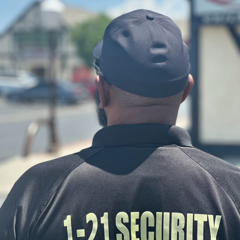 Uniformed 1-Twenty One Security standing officer on duty in Bakersfield